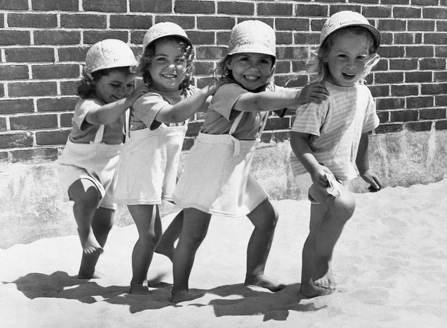 Black And White Photograph - Four Little Girls Having Fun by Underwood Archives
