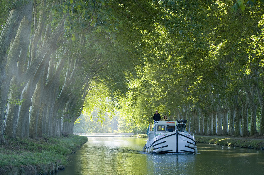 France, Languedoc, Carcassonne, boat in tree lined canal Photograph by Travelpix Ltd