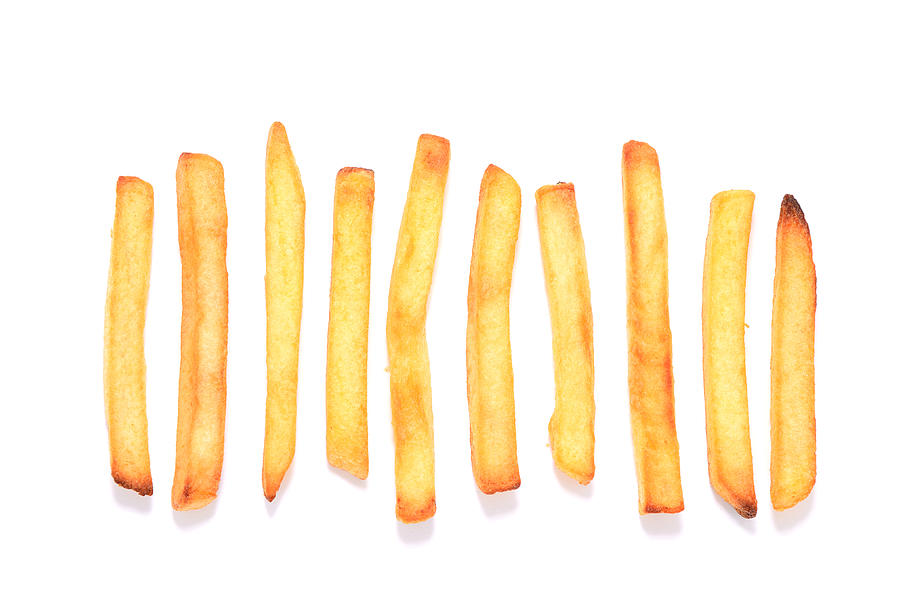 French fries in a row on white background Photograph by Knaupe