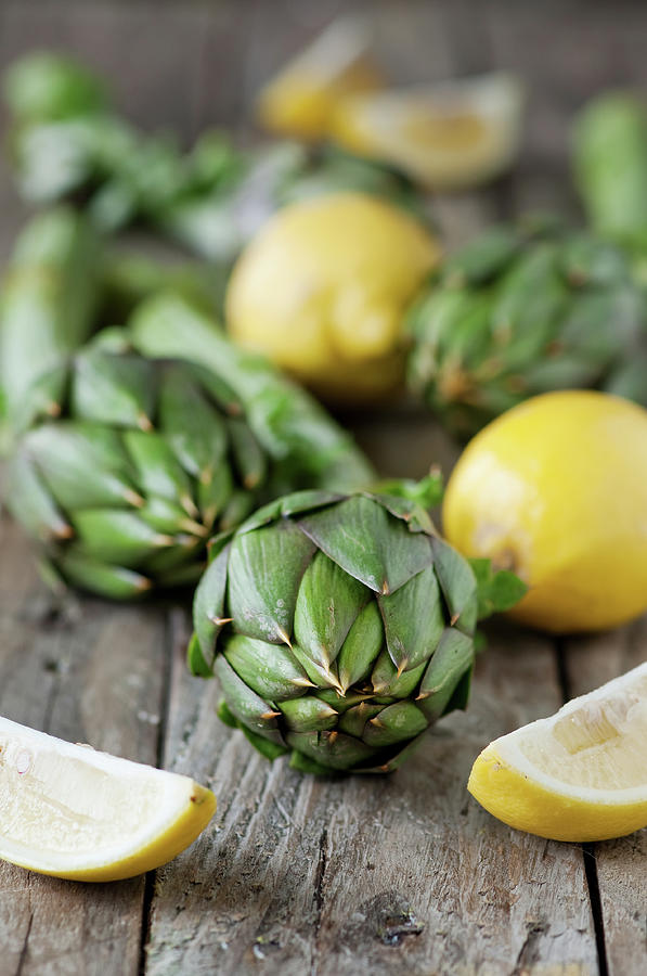 Fresh Artichoke And Lemons Photograph by Oxana Denezhkina