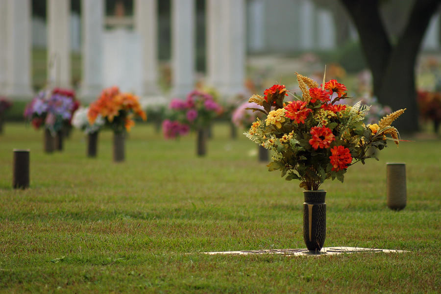 Fresh flowers in vases at a cemetery Photograph by Jondpatton