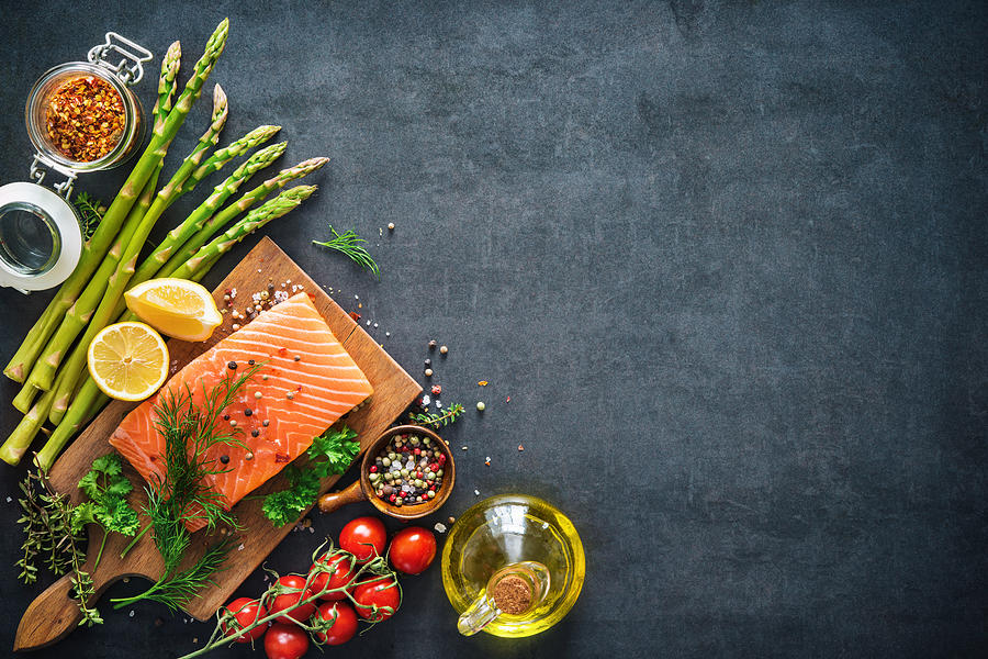 Fresh salmon fillet with aromatic herbs, spices and vegetables Photograph by AlexRaths