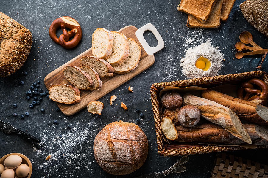 Freshly baked bread on wooden table Photograph by Ansonmiao