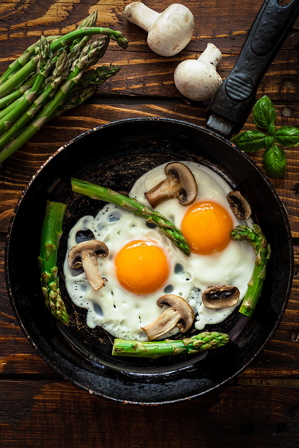 Fried Eggs With Asparagus Photograph by Kajakiki