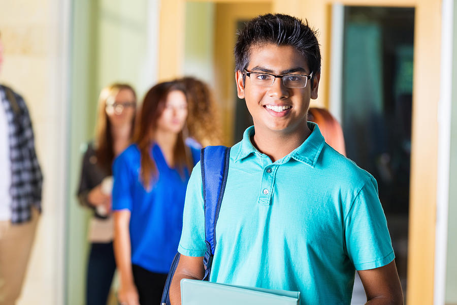 Friendly Indian high school student smiling in hallway Photograph by Steve Debenport