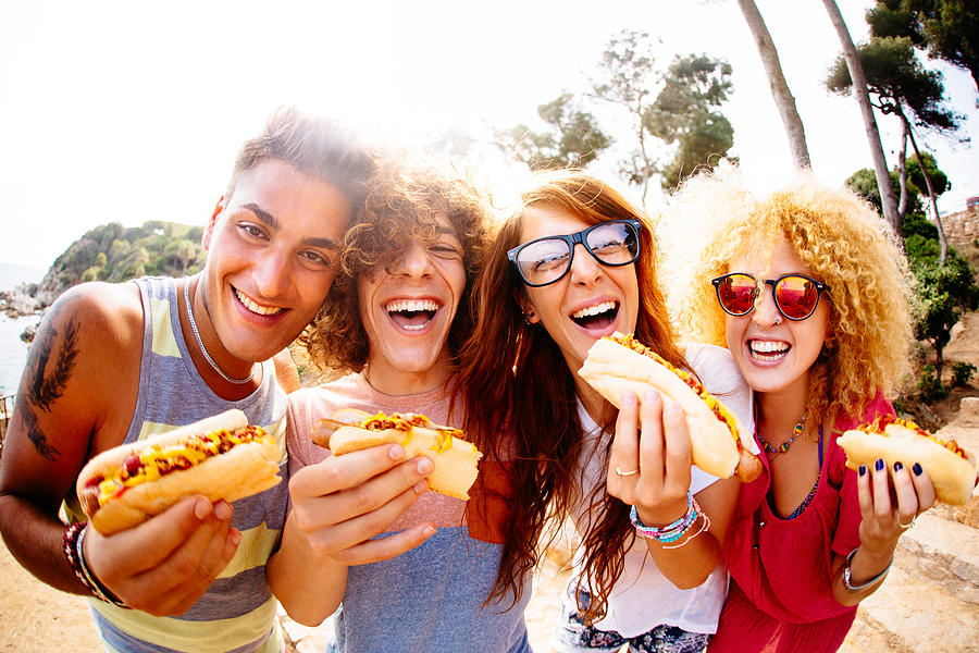 Friends Eating Hotdogs Photograph by Wundervisuals