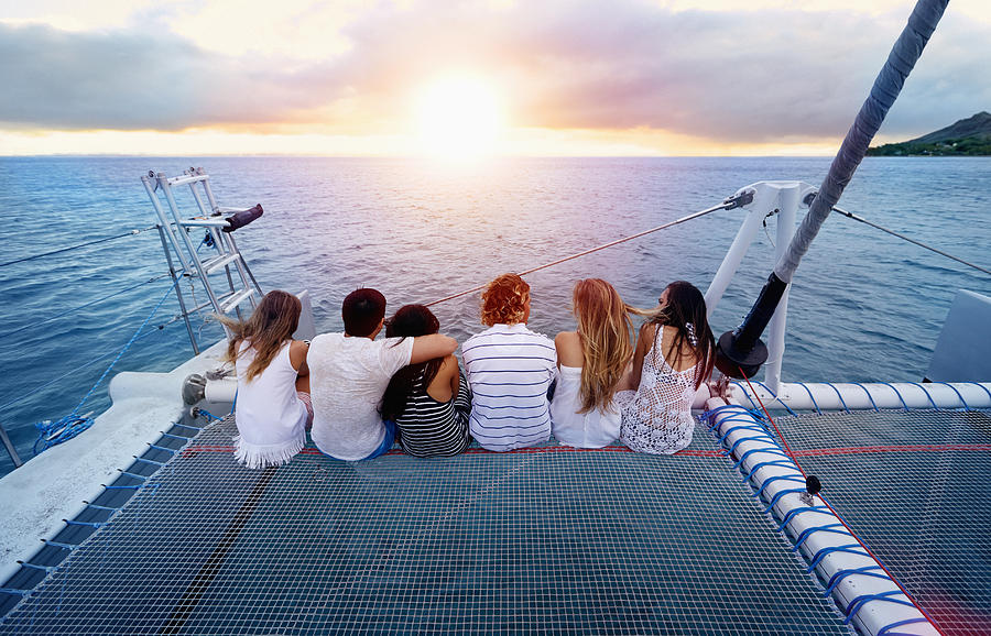 Friends relaxing on boat in ocean Photograph by Colin Anderson Productions pty ltd