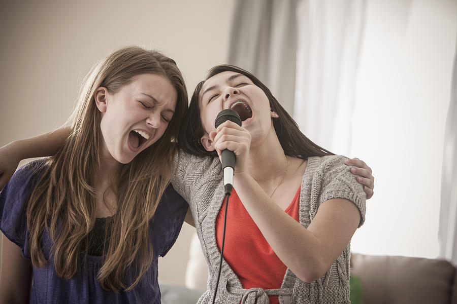 Friends singing karaoke together Photograph by John Fedele