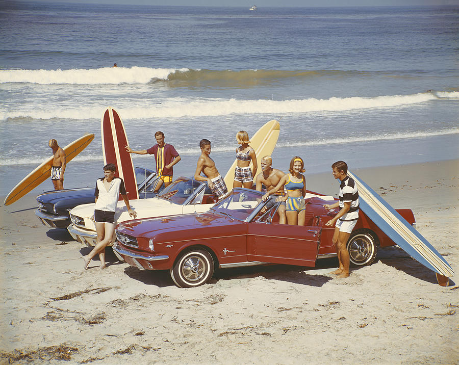 Friends with surfboards in car on beach Photograph by Tom Kelley Archive