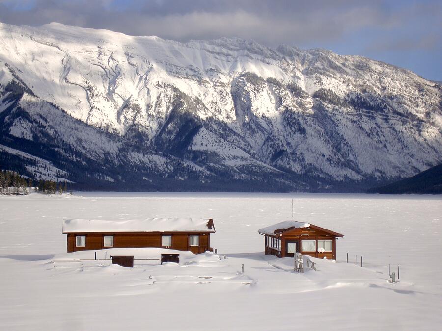 Frozen Snow Winter Docks - Lake Minnewanka, Banff National Park, Alberta, Canada Photograph by Ian McAdie