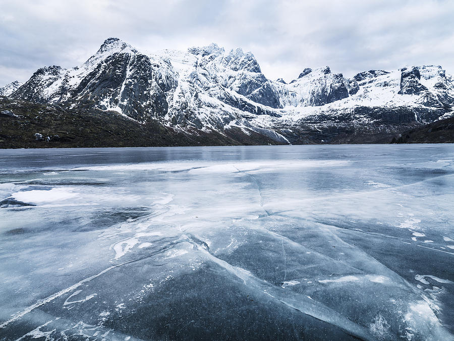 Frozen water and mountain range on background Photograph by Johner Images