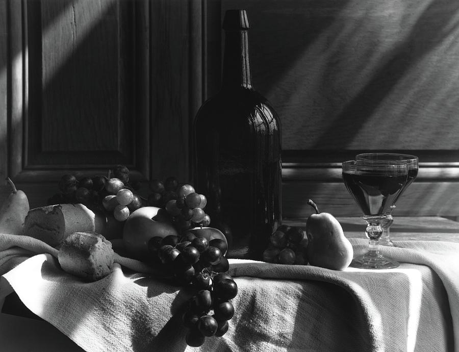 Fruit And Bread By A Wine Bottle Photograph by Horst P. Horst