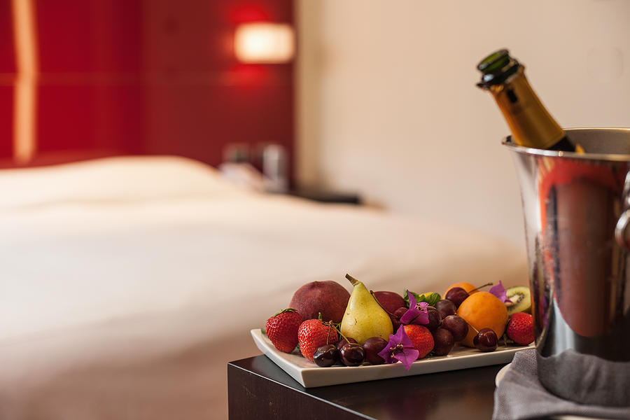Fruit plate and champagne in hotel room Photograph by Antonio Saba