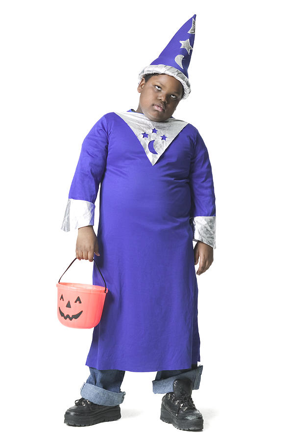 Full Body Shot Of A Slightly Annoyed Male Child Dressed As A Wizard For Halloween Photograph by Photodisc