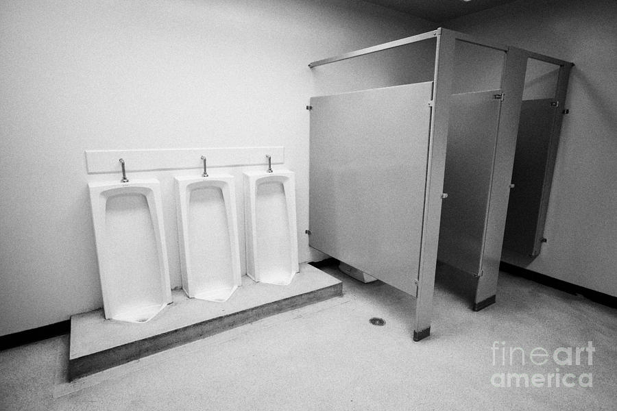 full length urinals and cubicles in mens toilet of High school canada north  america by Joe Fox