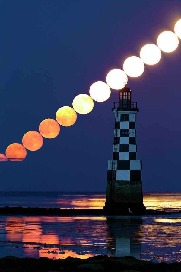 Full Moon Rising Over Lighthouse Photograph by Laurent Laveder