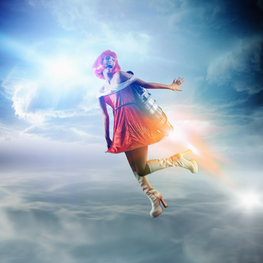 Futuristic Pacific Islander woman flying with jetpack Photograph by Colin Anderson Productions pty ltd