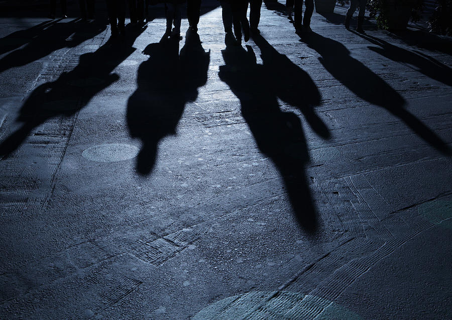 Gang of people advancing on viewer night shadows Photograph by CribbVisuals