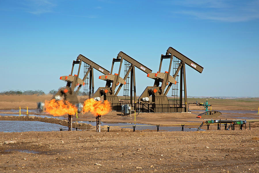 Gas Flares And Pumps At An Oil Field Photograph by Jim West