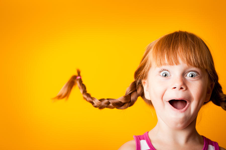 Gasping Red-Haired Girl with Upward Braids and Excited Look Photograph by Ideabug