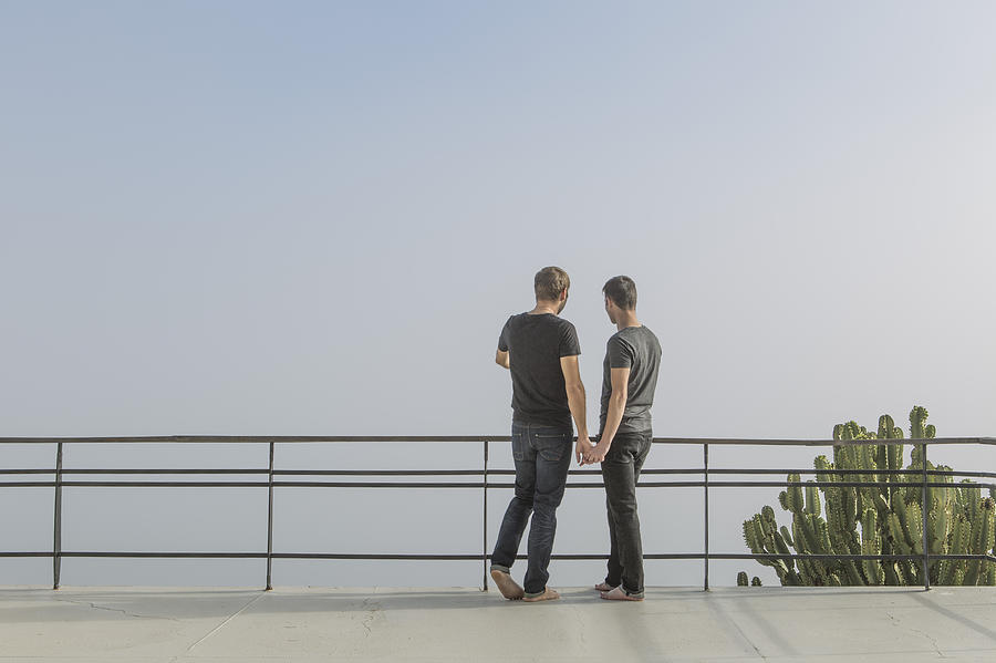 Gay couple standing on a balcony Photograph by Westend61