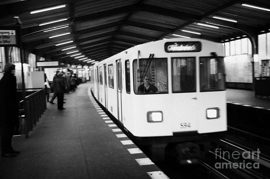 Berlin Photograph - german u-bahn underground train travels through overground station Berlin Germany by Joe Fox