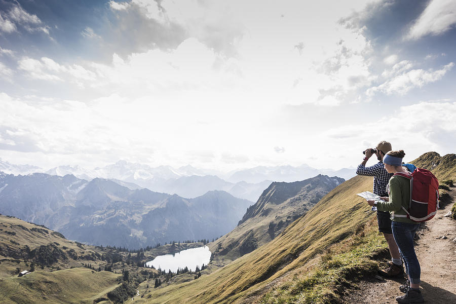 Germany, Bavaria, Oberstdorf, two hikers with map and binoculars in alpine scenery Photograph by Westend61