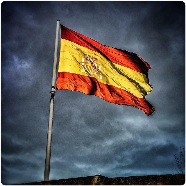 Giant Spanish Flag Backlit By The Photograph by Adam Jason Moore