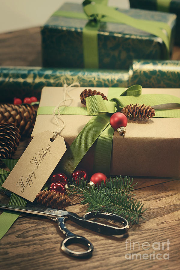 Gifts with tag for the holidays on wood table Photograph by Sandra Cunningham