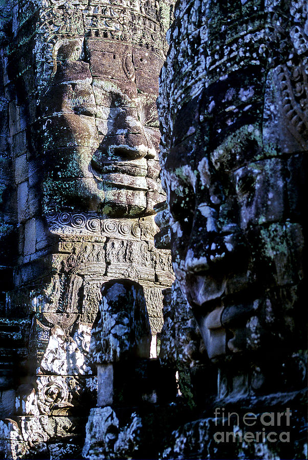 Ancient Ruins Photograph - Gigantic face statues at Khmer temple Angkor Wat ruins Cambodi by Ryan Fox