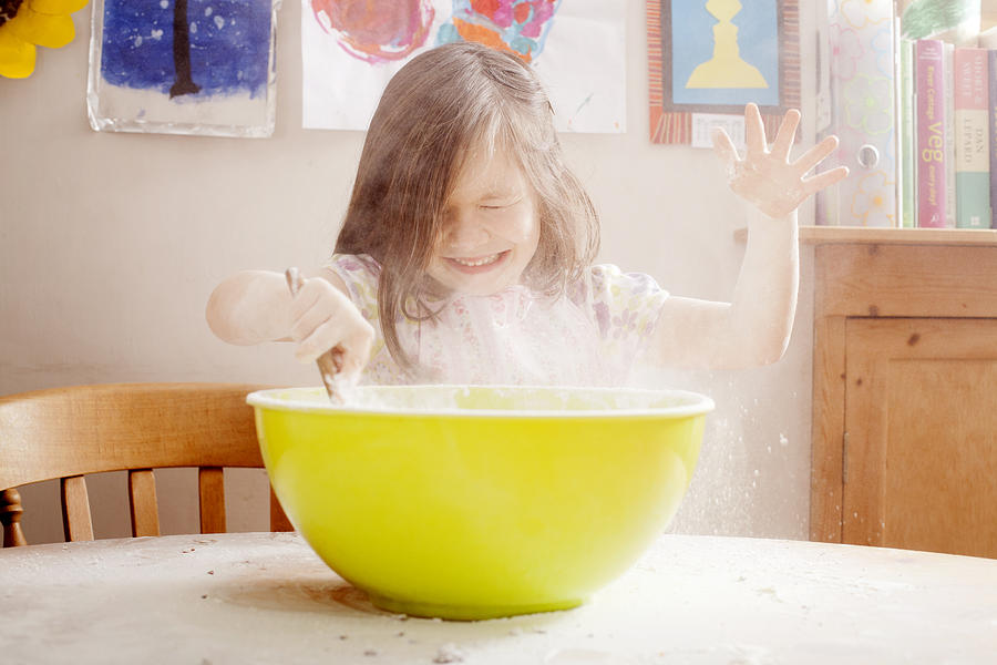 Girl (4-5) Mixing Flour In Bowl Photograph by Jw Ltd