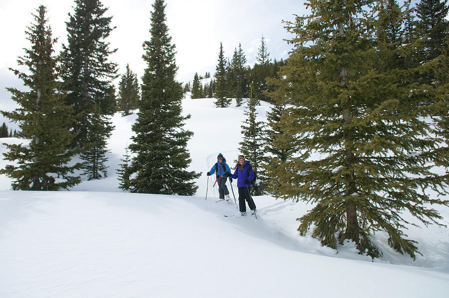 Winter Photograph - Girl And Boy Backcountry Skiing by Kennan Harvey