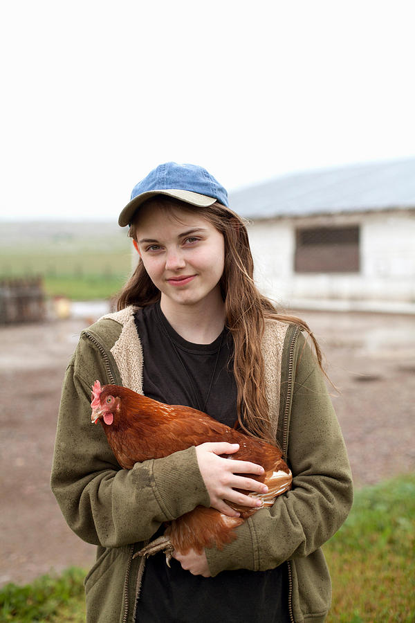 Girl carrying hen Photograph by Vicky Kasala