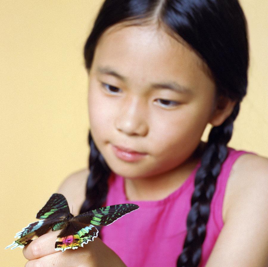 Butterfly Photograph - Girl Holding A Butterfly by Richard Bailey/science Photo Library