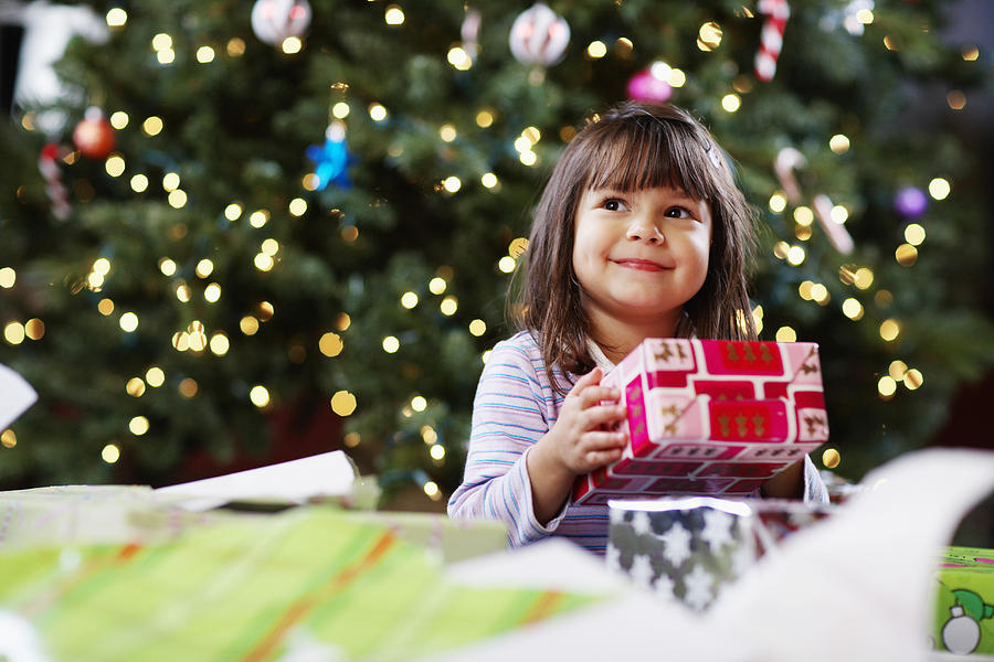 Girl Holding Christmas Gift Photograph by Fuse