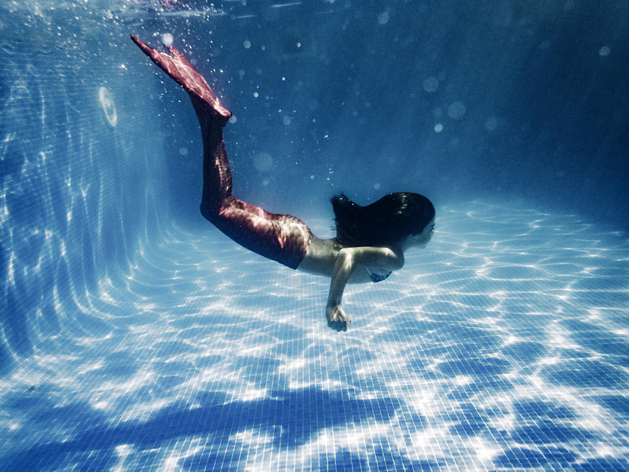 Girl in mermaid costume diving in pool Photograph by Aluxum