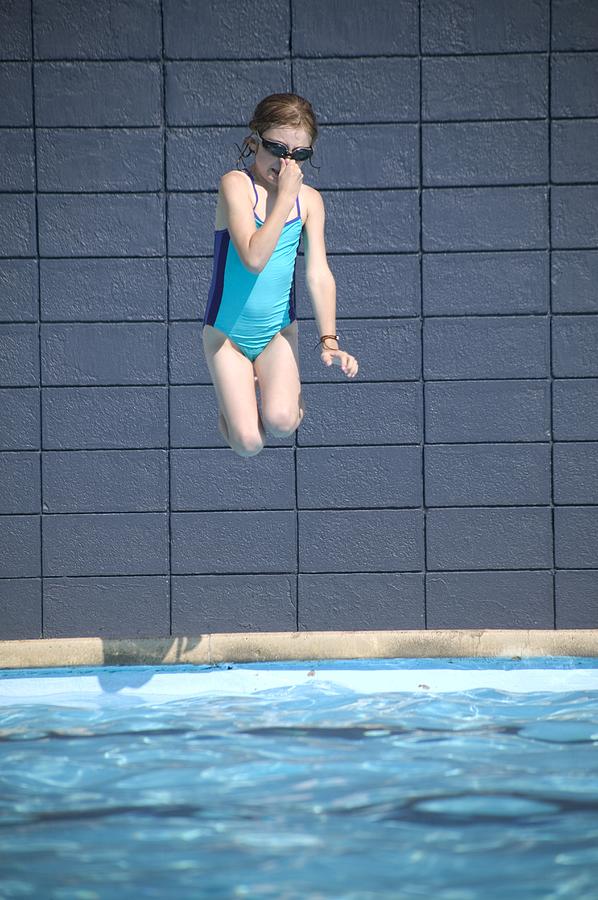 Girl Jumps Into The Pool Photograph