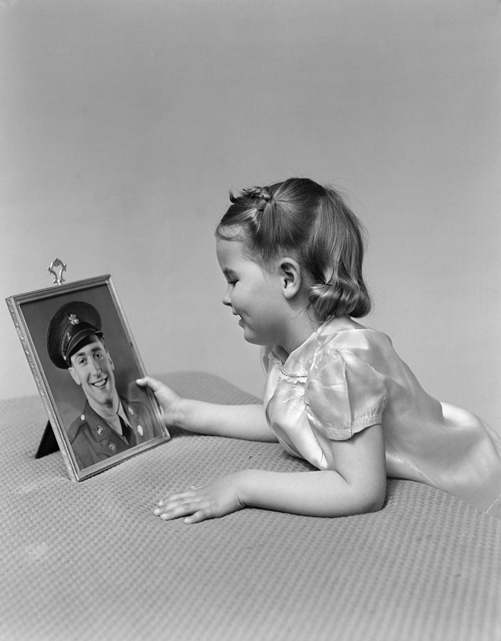 Vintage Photograph - Girl Looking At Picture Of Father by H. Armstrong Roberts/ClassicStock