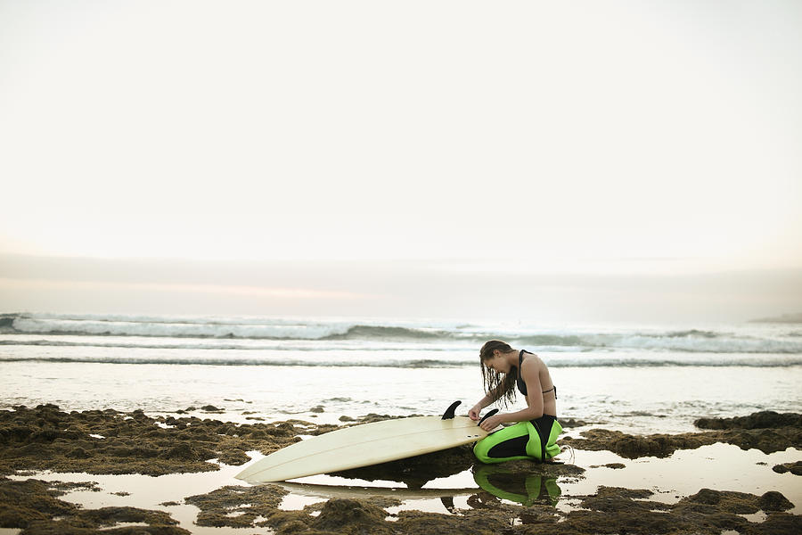 Girl Preparing Surfing Board On Rocky Photograph by Stanislaw Pytel