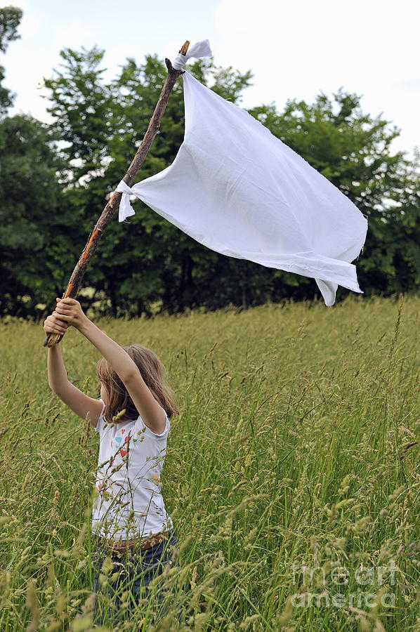 Girl raising the white flag in wheat field Photograph by Sami Sarkis