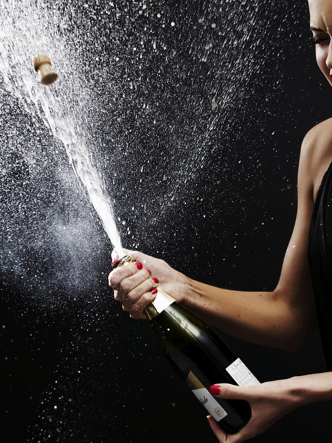 Girl shaking up bottle of champagne Photograph by Elizabeth Hachem