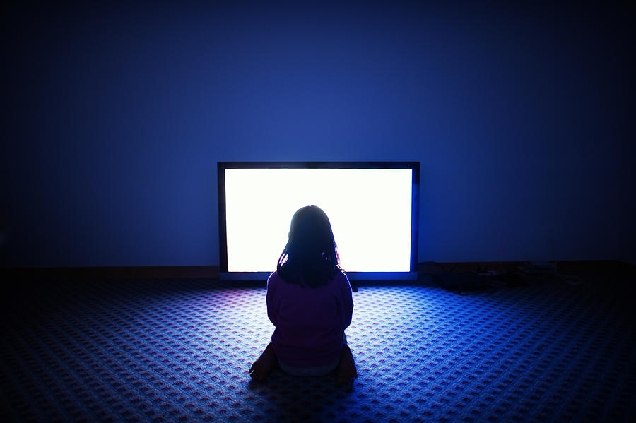 Girl sitting in front of television Photograph by Donald Iain Smith