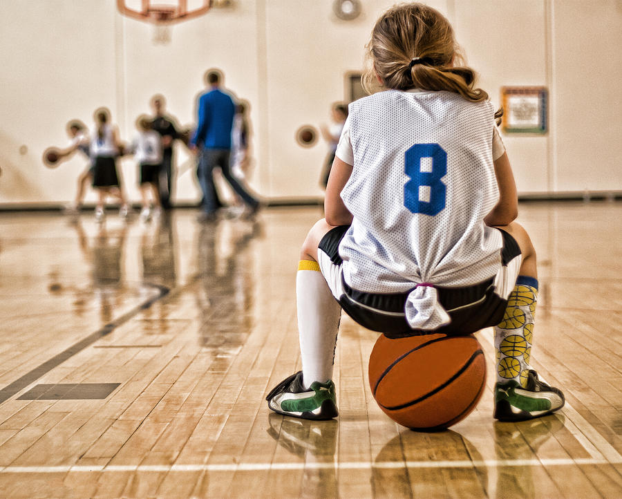 Girl sitting on basketball Photograph by Krista Long