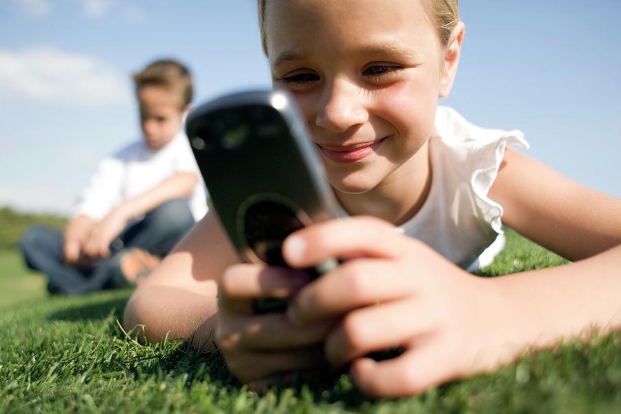 Girl Using A Mobile Phone By Ian Hooton Science Photo Library