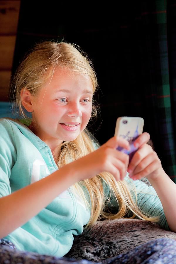 Indoors Photograph - Girl Using A Smartphone by Samuel Ashfield