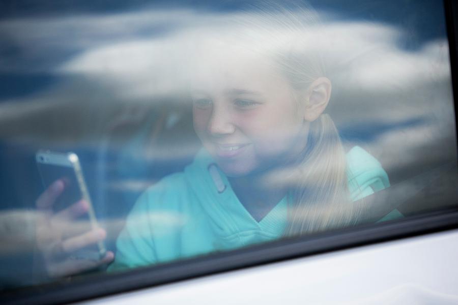 Girl Photograph - Girl Using Smartphone In Car by Samuel Ashfield