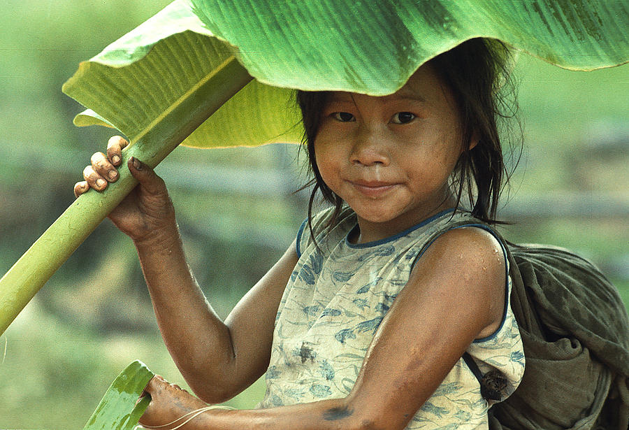 Umbrella Photograph - Girl With Banana Leaf Umbrella by Carl Purcell