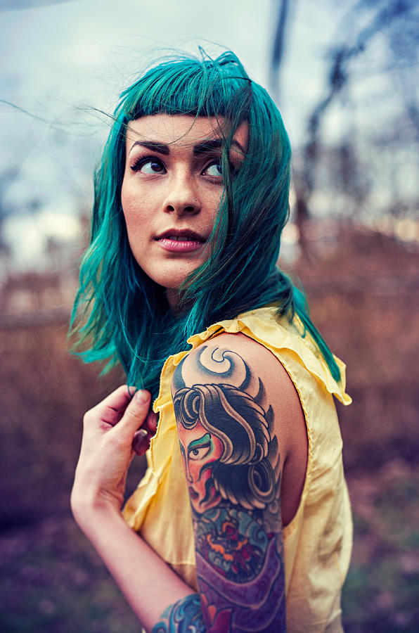 Girl with blue hair and tattoos looking over Photograph by Marie Killen