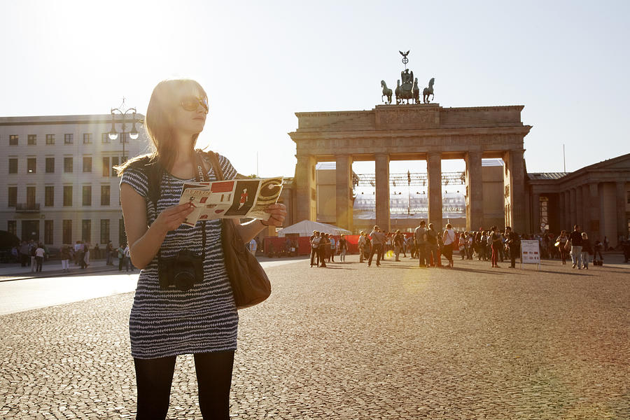 Girl with map at Brandenburger Tor Photograph by Chris Tobin