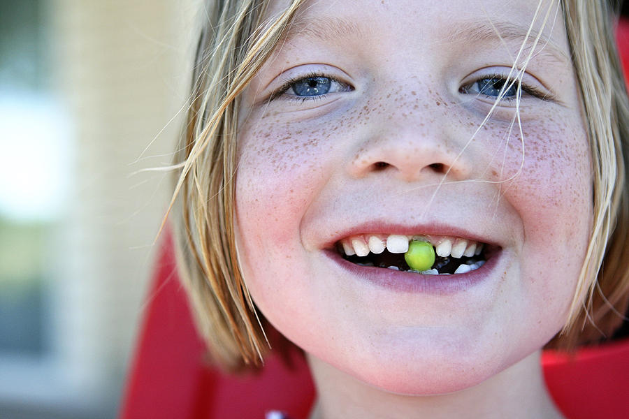Girl with pea in mouth Photograph by Images by Marvett Smith